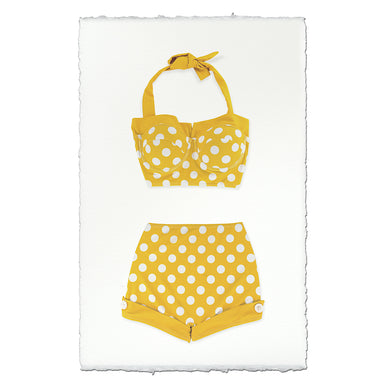 Yellow polka dot bikini set on a textured white paper